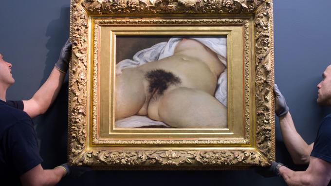 (FILES) This file photo taken on June 3, 2014 shows two hauliers installing the Gustave Courbet's canvas "L'origine du monde" (The origin of the world) at the Courbet museum in Ornans, eastern France. The young woman who served as a model for Gustave Courbet to paint "The Origin of the World" was called Constance Queniaux, reveals French writer Claude Schopp in a book "The origin of the world, life of the model" (L'Origine du monde, vie du modele) to be released on October 4, 2018. / AFP PHOTO / SEBASTIEN BOZON