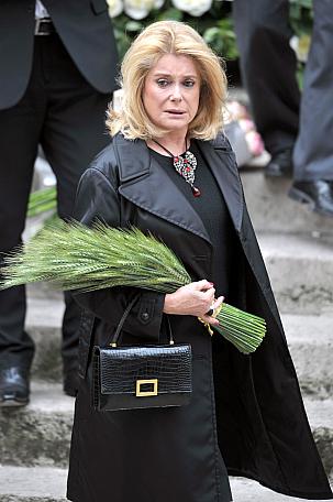French actress Catherine Deneuve arrives, on June 5 2008 at the Saint-Roch church in Paris, to attend the funeral mass held by father Roland Letteron for fashion designer Yves Saint-Laurent. Saint Laurent, one of the 20th century's greatest couturiers, credited for revolutionising women's wardrobes, died on June 1, aged 71 of a brain tumour. AFP PHOTO MARTIN BUREAU